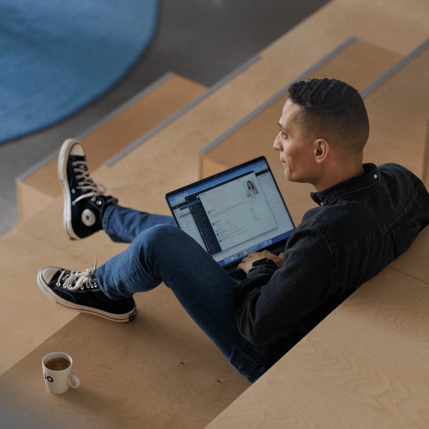 Male coworker sitting with laptop