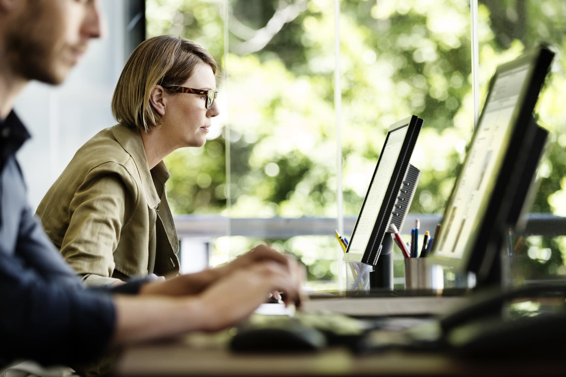 Man and woman working desk computer
