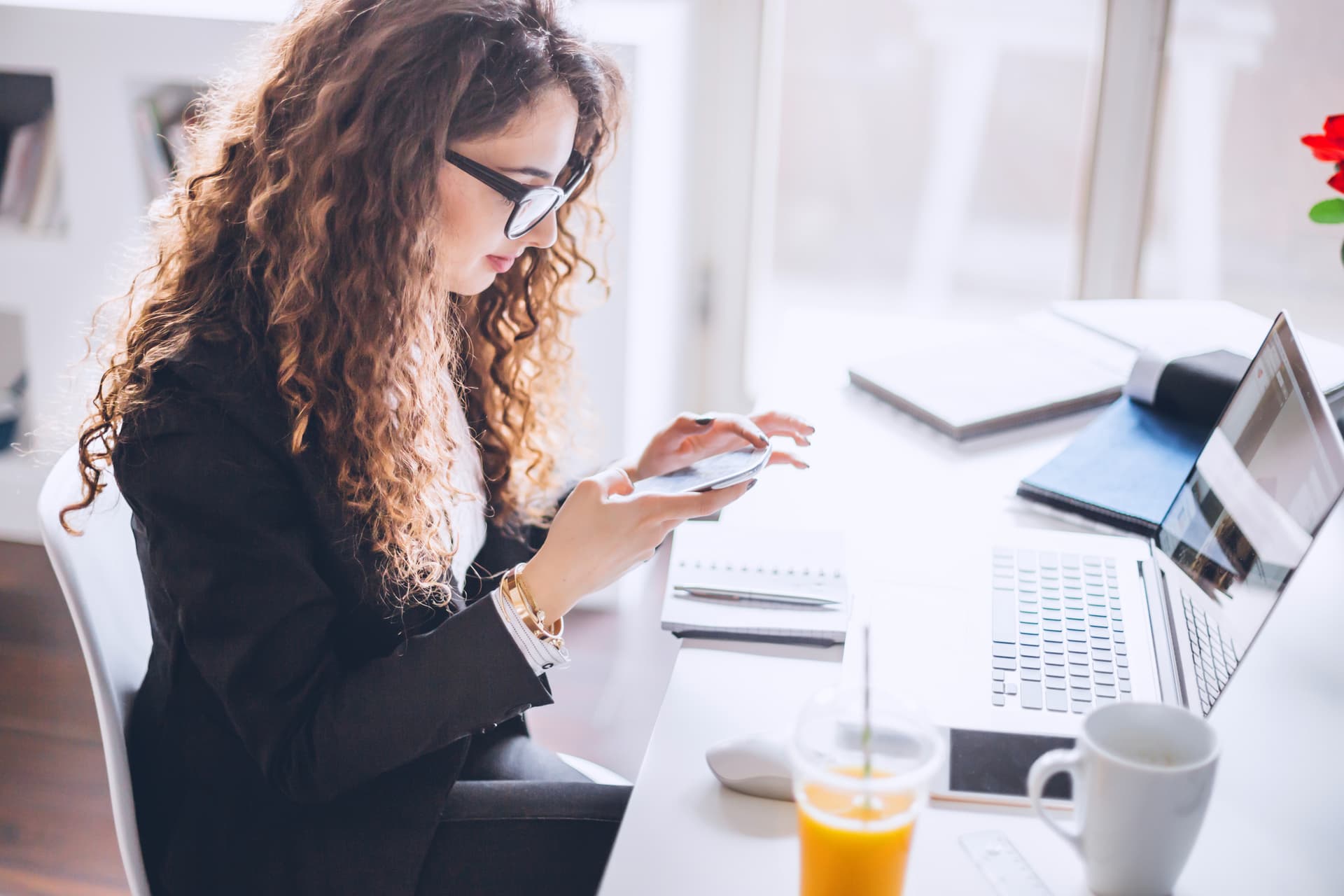 person with phone and laptop