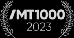 Laurel wreath surrounding the text "MT1000 2023" in a stylized silver font.