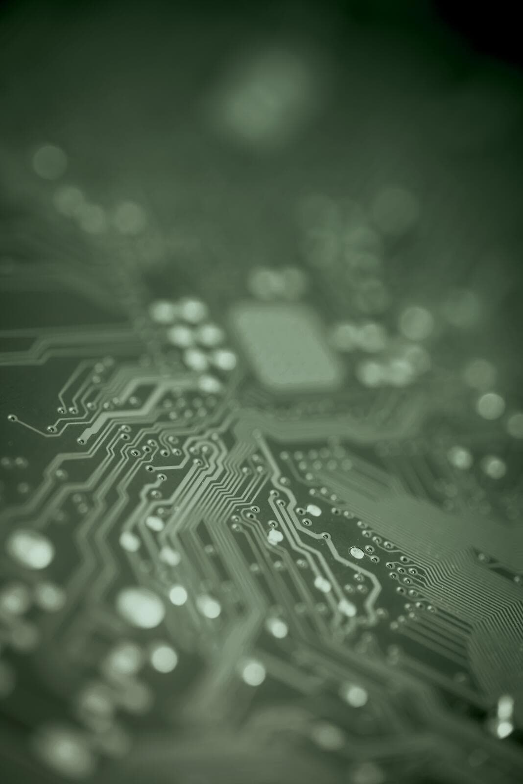 Close-up view of a green computer circuit board with intricate traces and components.