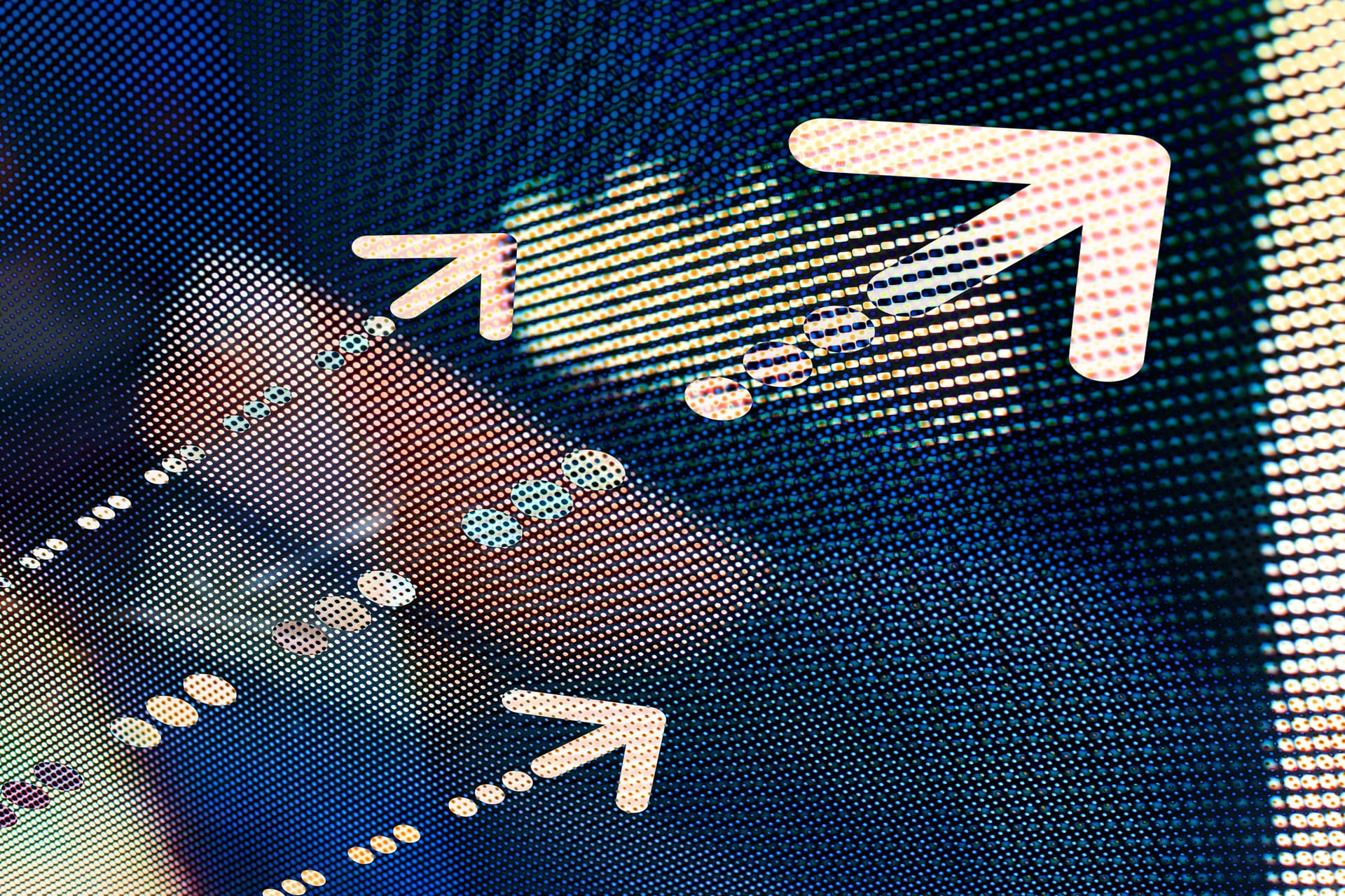 Close-up of a digital screen with pixelated background, featuring bright arrows and dots moving diagonally, creating a dynamic pattern.