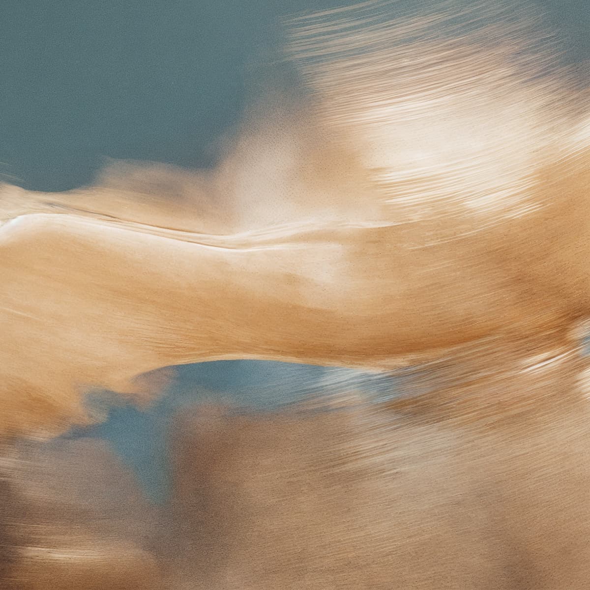 Abstract image of swirling beige and blue tones creating a fluid, dynamic motion across the canvas.