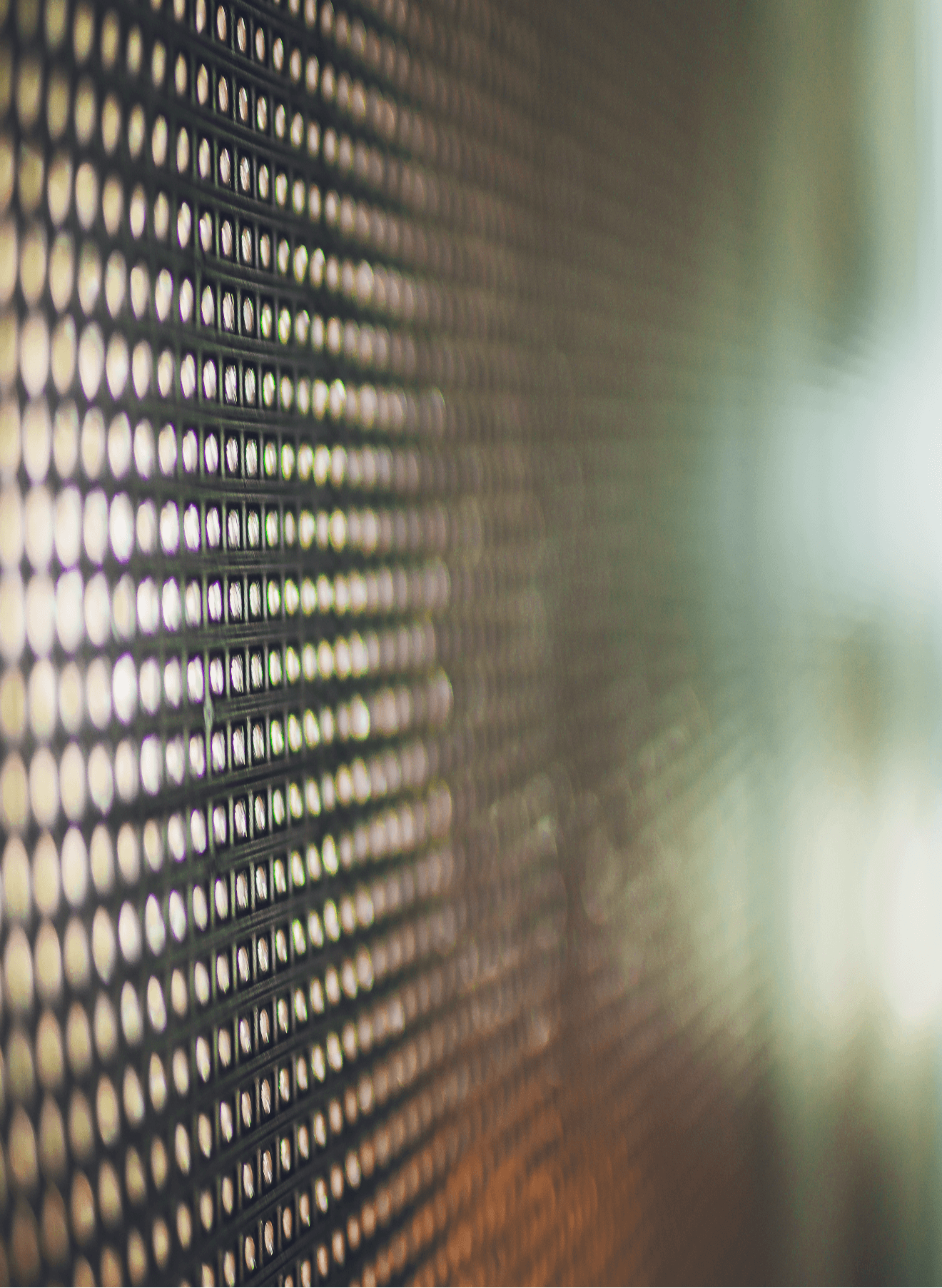 Close-up of an LED display with small lights arranged in a grid pattern, fading into a soft blur on the right side.