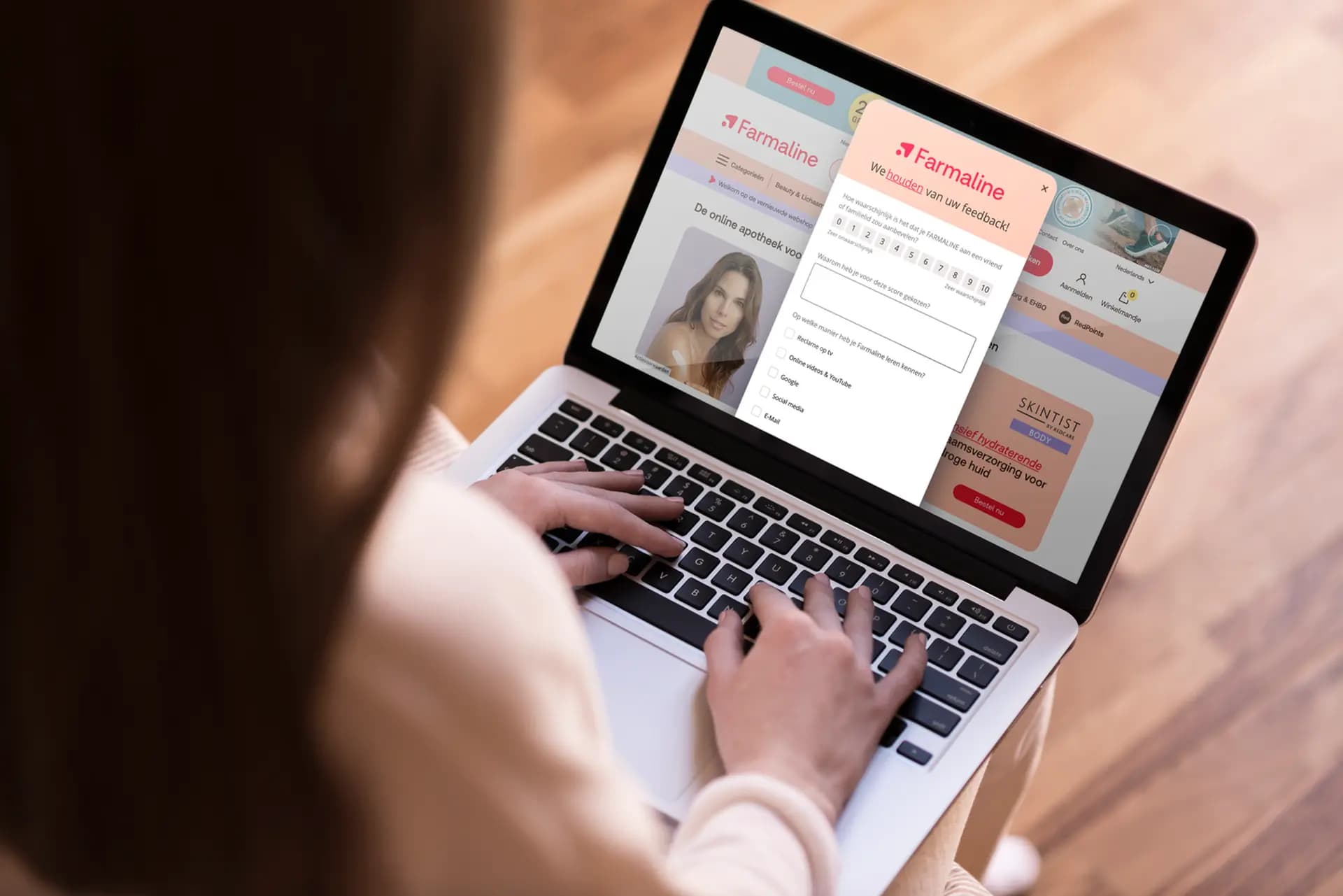 Person typing on a laptop displaying the Farmaline website with a feedback form page open.