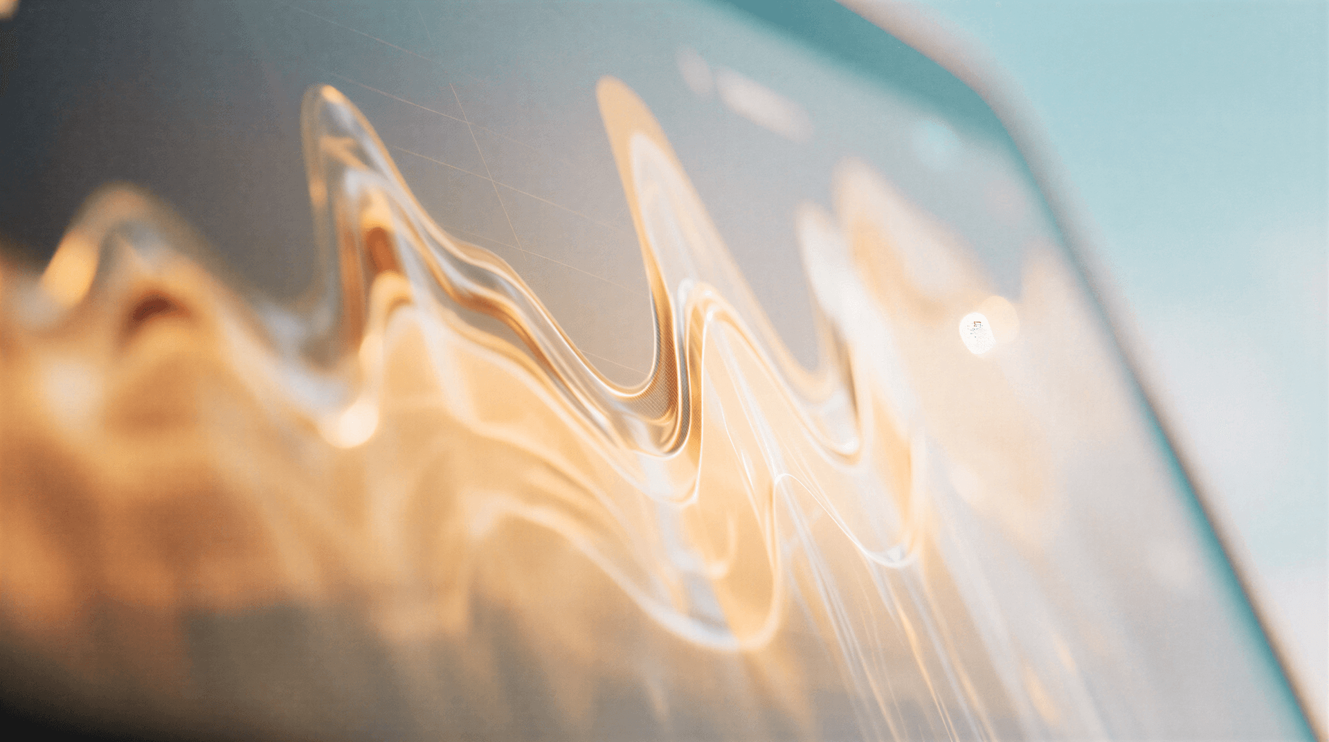 Abstract image with golden wave-like patterns on a screen, blending softly into a gradient blue background.