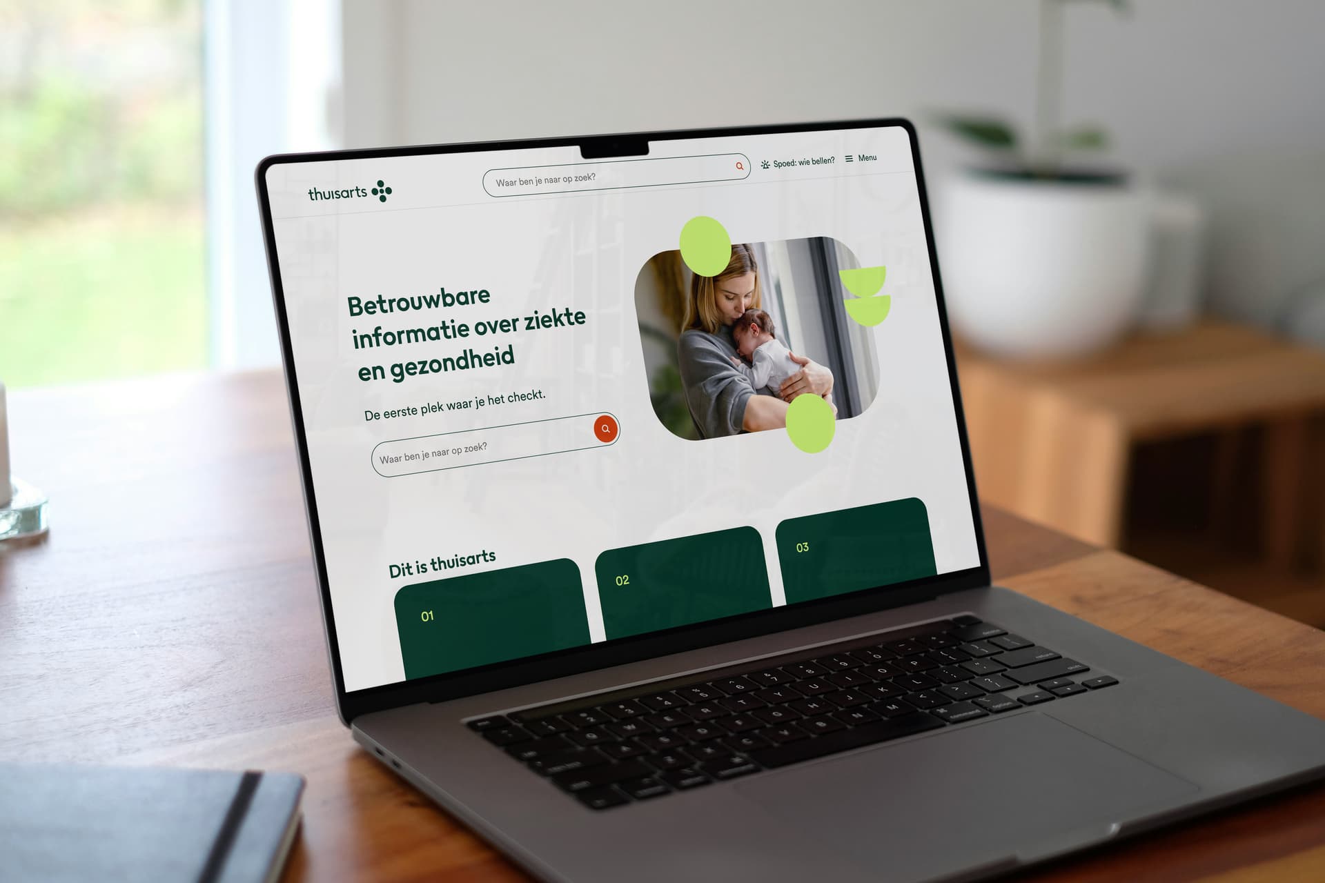 A laptop on a table displaying a Dutch health information website with a search bar and an image of a woman holding a baby.