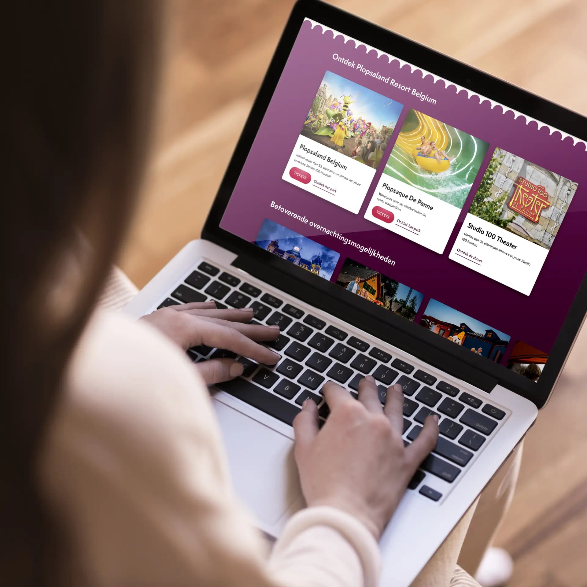 Person browsing a website for Plopsaland Resort Belgium, displaying options for tickets and attractions on a laptop screen.