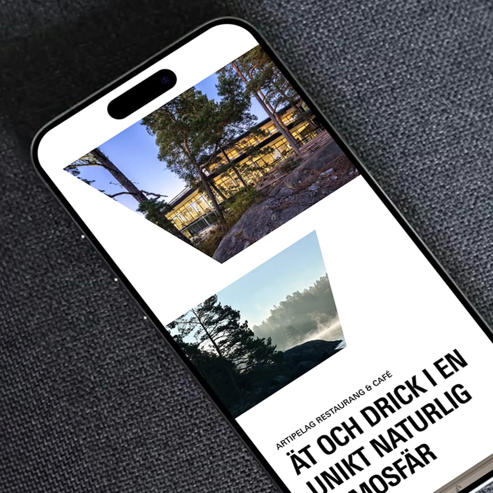 A smartphone displaying images of a scenic building surrounded by trees and a misty landscape, with text promoting a restaurant and café experience.