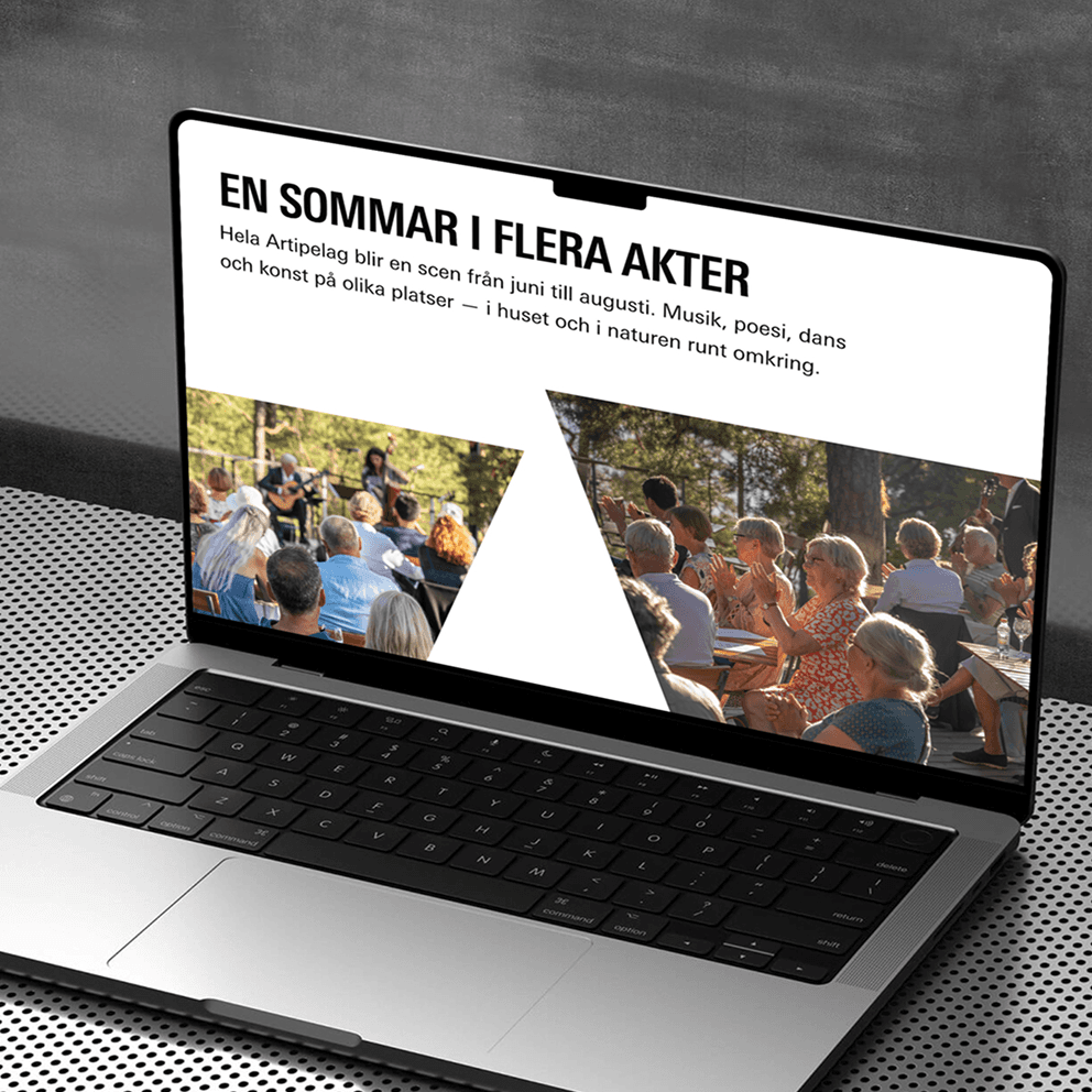 Laptop on a table displaying a website about summer events featuring music, poetry, dance, and art, with images of people clapping outdoors.